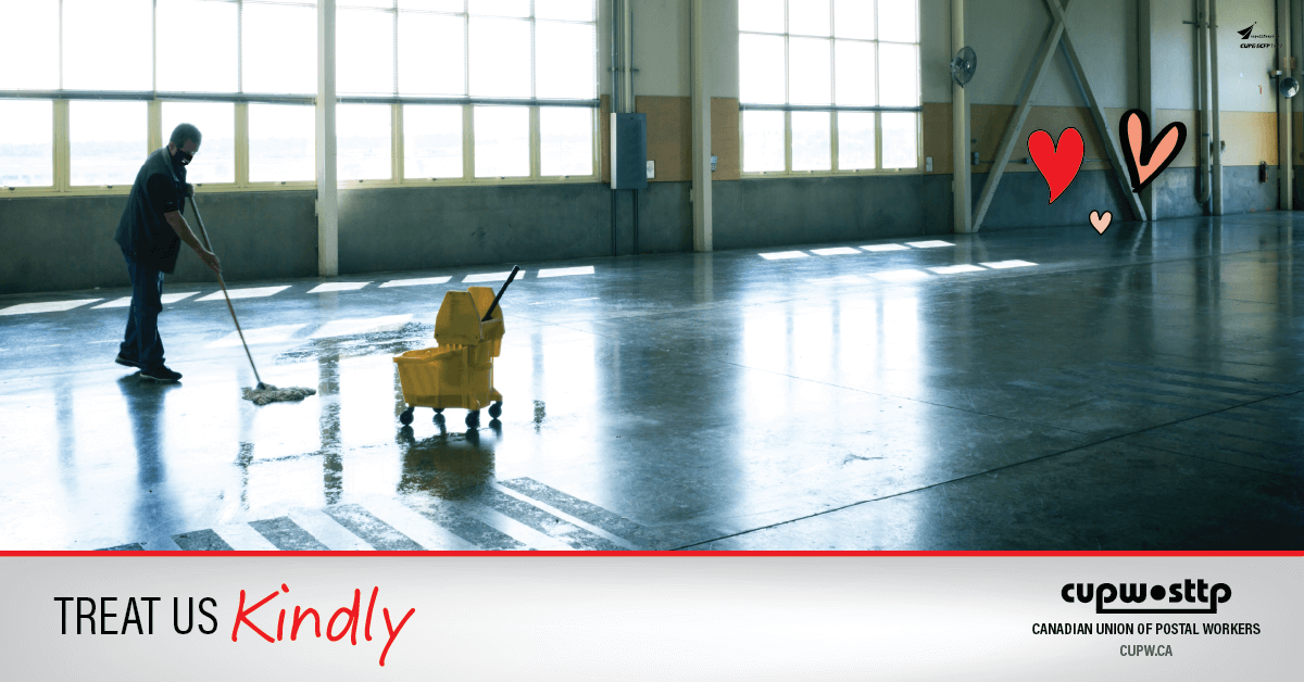 Photo of a cleaner mopping the floor of an empty warehouse.